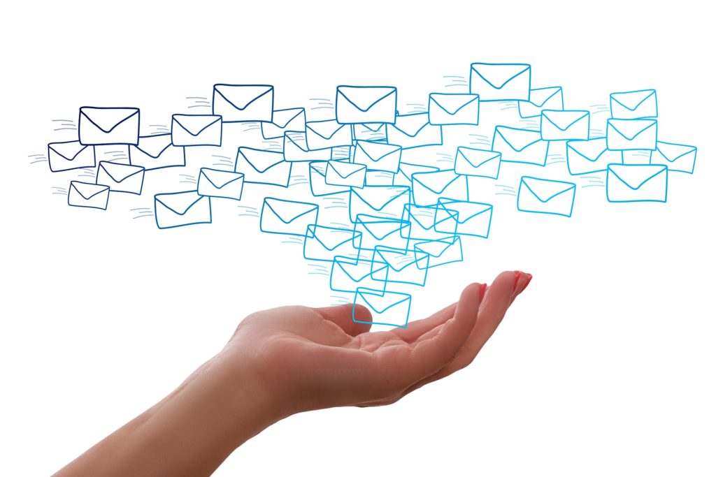 An illustration featuring many mail envelopes floating above a hand against a white background.